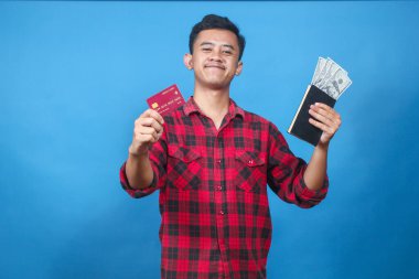 Asyalı adam elinde dolar ve kredi kartı içeren bir kitap tutuyor. Neşeli bir ifadeyle bonus alıyor.