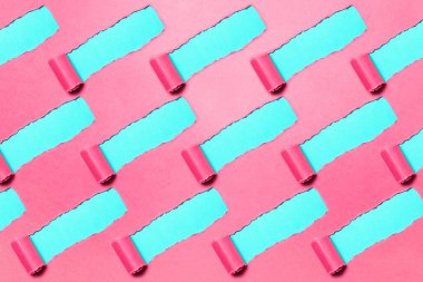 Pattern of diagonally torn pink paper on blue background.