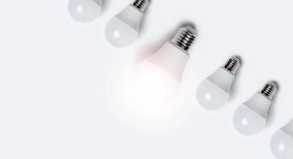 Close Light Bulbs One Glowing White Background — Stock Photo, Image