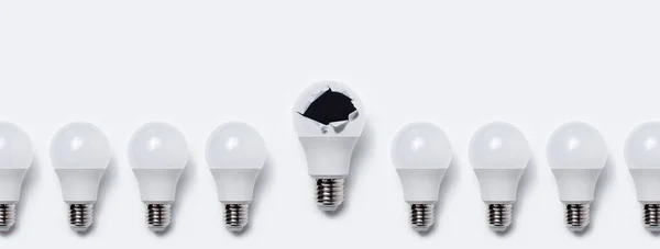 Close Many Light Bulbs One Bulb Torn Hole White Background — Stock Photo, Image