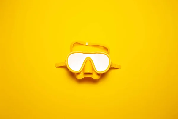 Top view of yellow diving mask isolated on yellow background.