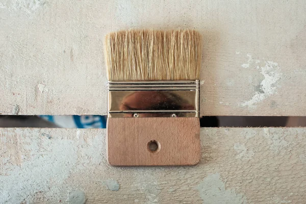 Close-up of construction brush of wooden table.