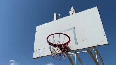 Mavi gökyüzünün arka planında basketbol potası manzarası.