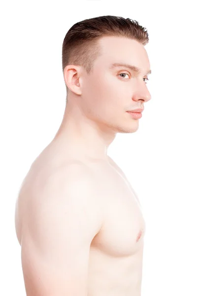 Όμορφος άνδρας σε λευκό φόντο με ένα γυμνό κορμό στο μπλε τζιν — Φωτογραφία Αρχείου