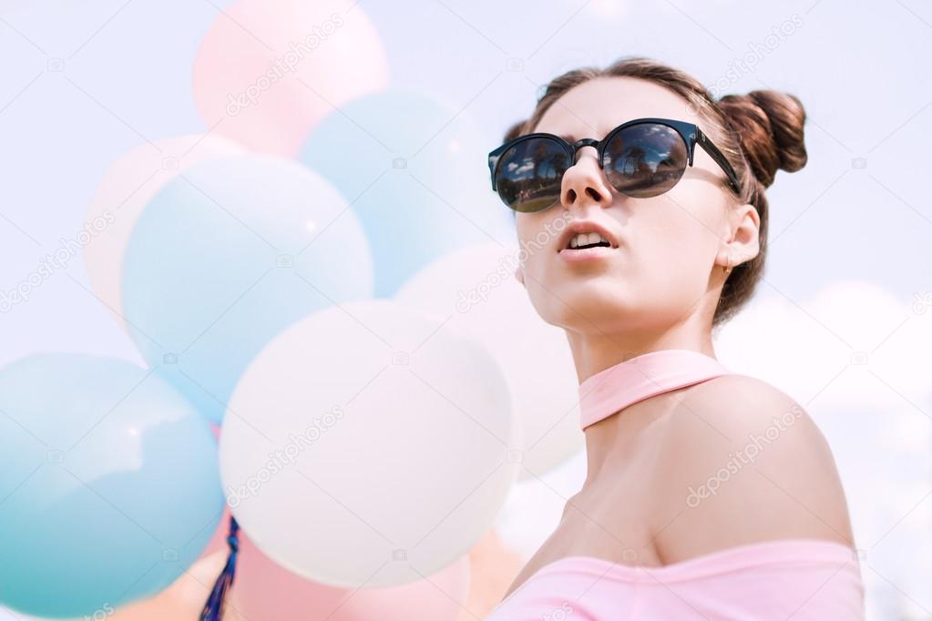 The birthday of the beautiful girl in sunglasses with balloons