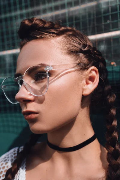 Girl in glasses with pigtails outdoors — Stock Photo, Image