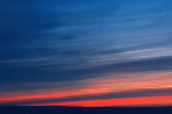 Beautiful sunset sky with stripes of red and blue