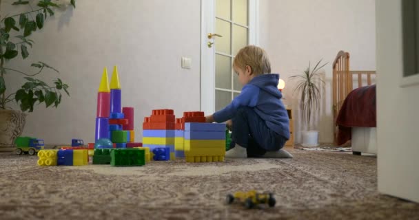 Happy Little Child Speelt Met Speelgoed Brick Constructor Tapijt Vloer — Stockvideo