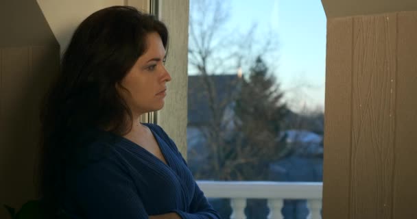 Sad Thoughtful Woman Stands Thinking Waiting Looking Out Window Backyard — Stock Video