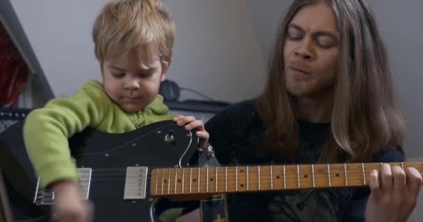 Young Rocker Musician Man Teaches Child Playing Electric Guitar 아버지 — 비디오