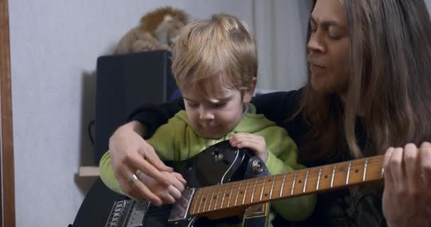 Young Rocker Musician Man Teaches Child Playing Electric Guitar Father — Stock Video