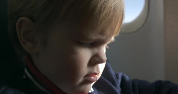 Little Boy Leads Watching Menu Book Passenger Seat Board Airplane — Vídeo de Stock