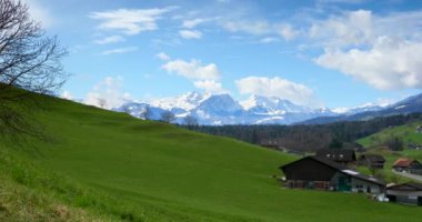 Resimli Alpler Dağları. Country Road Manzarası. Yeşil Çimen Çayırı. Village 'daki kulübeler. İsviçre Avrupa