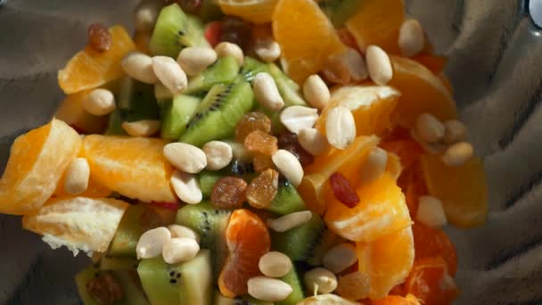 Close Sunflower Seeds Fall Fruit Salad Kiwi Orange Raisins Peanuts — 비디오
