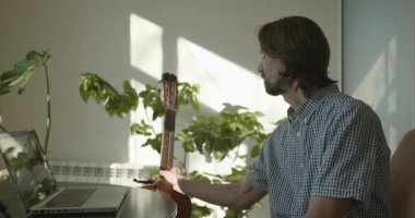 Bilgisayarı kullanarak Müzisyen Öğretmen Gitar Dersi Veriyor. 4K 10-bit