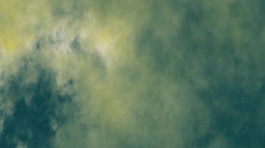 Sönük yeşil ve sarı tonlarda kıvrımlı ince bulutlar içeren soyut dokulu bir arka plan. Atmosferik elementler, ruh halleri ya da yaratıcı örtüler için mükemmel..