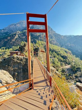 Dağ nehri üzerinde kırmızı metal bir köprü. Yüksek kalite fotoğraf