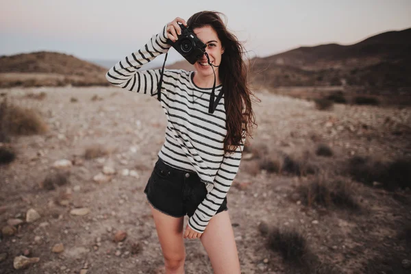 Cheerful brunette girl with digital camera — Stock Photo, Image