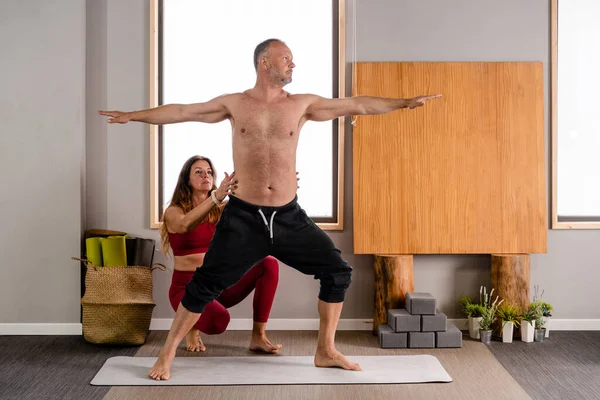 Concentrated Female Trainer Sportswear Teaching Man Performing Virabhadrasana Pose Yoga — Stock Photo, Image