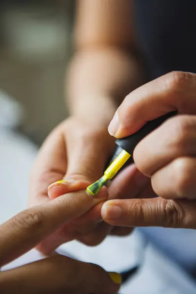 Crop Female Master Applying Yellow Polish Nails Anonymous Client Beauty — Stockfoto