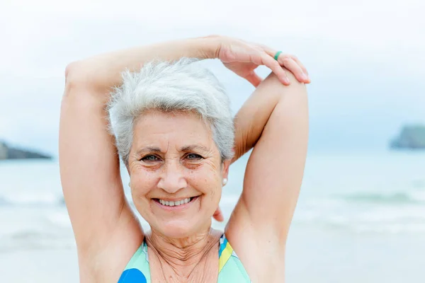 Positive Gray Haired Female Pensioner Swimsuit Stretching Shoulders Fitness Workout — Stock Photo, Image