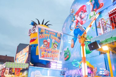 10.09.25. Bad Hersfeld, Germany, Amusement ride facade decorated with colorful game-style characters and bright lights. The vibrant carnival atmosphere reflects fun, energy and dynamic entertainment.