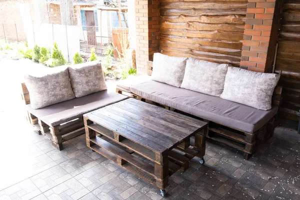 Furniture from pallets in the gazebo. Sofa and table in the barbecue lounge area.