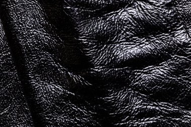 Siyah deri arkaplanın yakın plan görüntüsü.