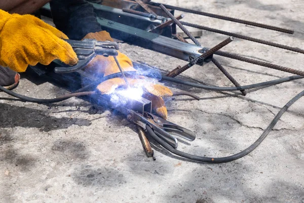 Welding work outdoors in a private house close-up.