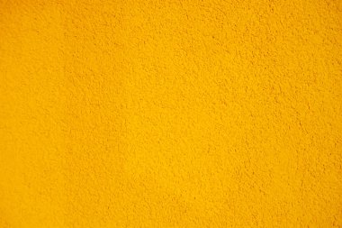 Parlak sarı doku. Turuncu arka plan. Renkli sarı arka plan. Parlak sarı tahıl yüzeyi. Sert sarı duvar..