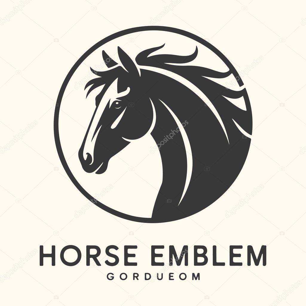 A striking dark horse emblem with a flowing mane, set within a circular frame, symbolizing power and elegance