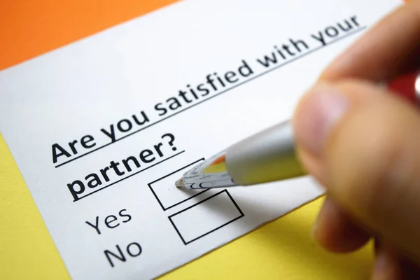 A person is answering question about satisfaction with partner.