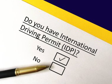One person is answering question. He has international driving permit  clipart