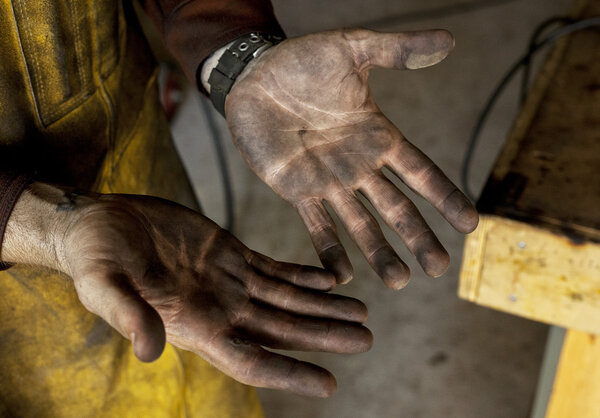 A welder's dirtied hands after a long afternoon of labor.
