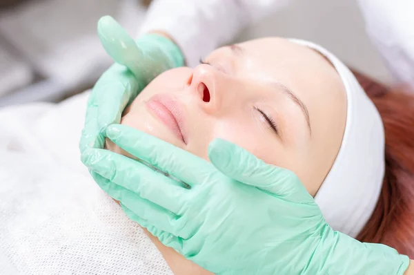 Beautiful girl gets face peeling. Skin health concept. Beauty salons. Mixed media