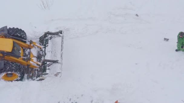Gele trekker verwijdert sneeuw na sneeuwstorm, bovenaanzicht 13 november 2020 Oekraïne — Stockvideo