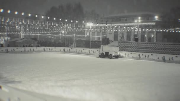 Ice recovery and maintenance machine on a skating rink, evening, lights, snowfall. Ukraine, Kiev January 14, 2021 — Stock Video