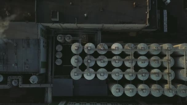 Aerial view of a drone flying over the beer production plant, several rows of tanks. — Stock Video