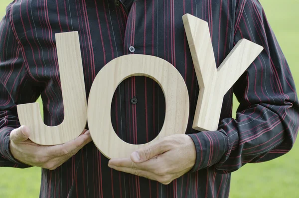 Hands holding the word Joy. — Stock Photo, Image