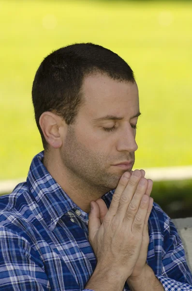 Portrait of man praying.