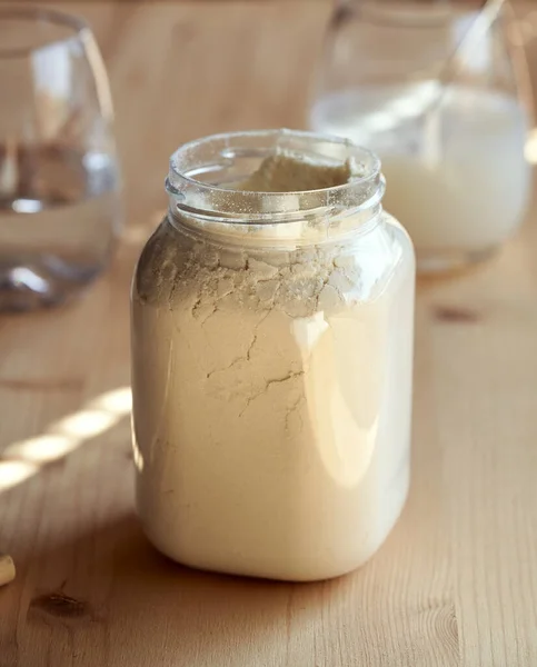 Σκόνη Πρωτεΐνης Ορού Γάλακτος Πλαστικό Δοχείο Ένα Τραπέζι — Φωτογραφία Αρχείου