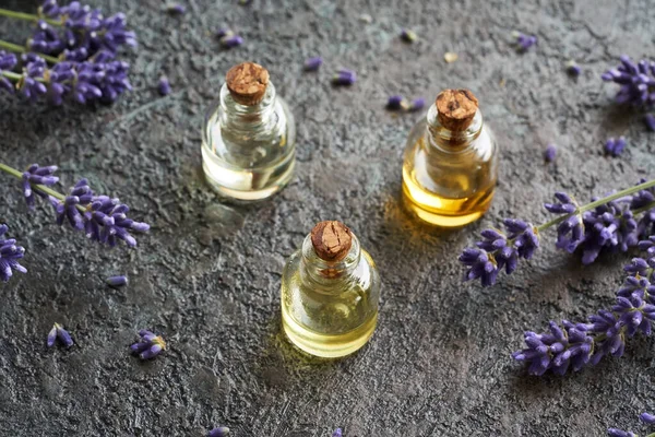 Three Bottles Essential Oil Fresh Blooming Lavender Dark Background Aromatherapy — Stock Photo, Image