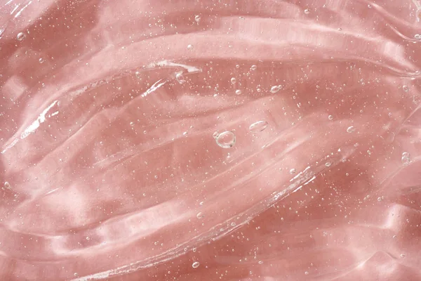 ピンクの背景に透明なアロエベラゲルの閉鎖 天然皮膚保湿剤 — ストック写真