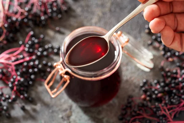 Hand Holding Spoon Homemade Black Elder Syrup Fresh Elderberries Background — Stock Photo, Image