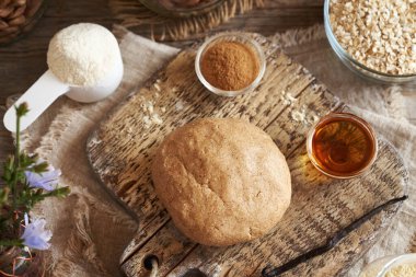 A ball of raw dough made of whey protein powder, ground oat flakes, maple syrup, vanilla and nut butter - preparation of homemade bars