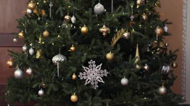 Altın süslemeleri ve ışıldayan ışıklarıyla zarif Noel ağacı rahat bir tatil ortamı yaratıyor.