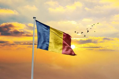 sunny blue sky and flags of moldova and romania