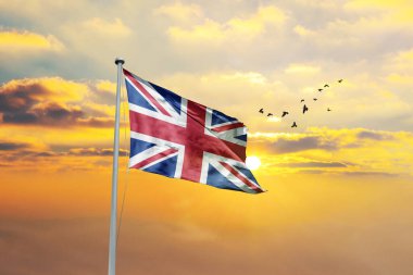 Gün batımında ya da gündoğumunda Birleşik Krallık bayrağı sallanıyor. Cumhuriyet Günü ve Bağımsızlık Günü için Birleşik Krallık bayrağı.