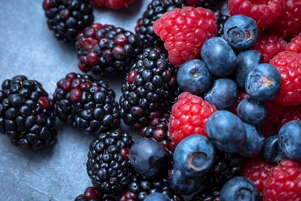 berries mix on an abstract gray background, seen from above.