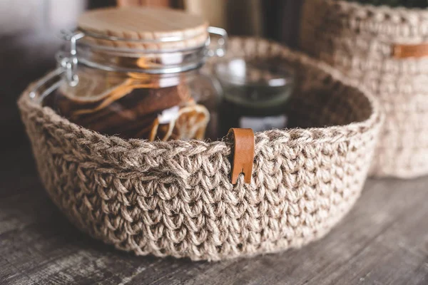 Eco friendly jute knitted baskets with decor, candle. Zero waste concept. Decor and interior.
